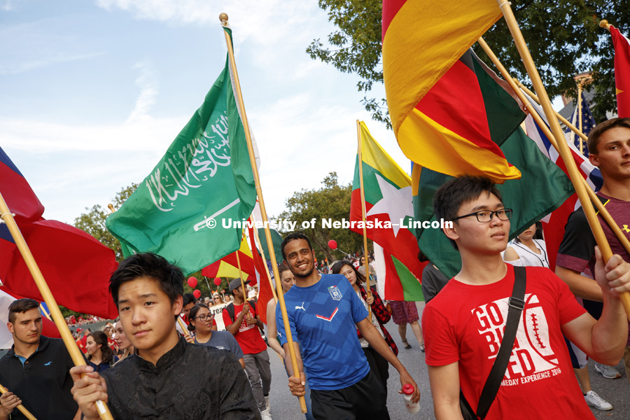International students carry flags from their homelands in the Homecoming Parade. Homecoming parade, pep rally and court jester competition. September 22, 2017. Photo by Craig Chandler / University Communication.