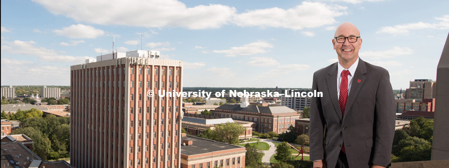 Michael Boehm, Vice Chancellor, Institute of Agriculture and Natural Resources, standing on top of a building with the University of Nebraska – Lincoln City Campus in the background. October 10, 2017. Photo by Greg Nathan, University Communication.