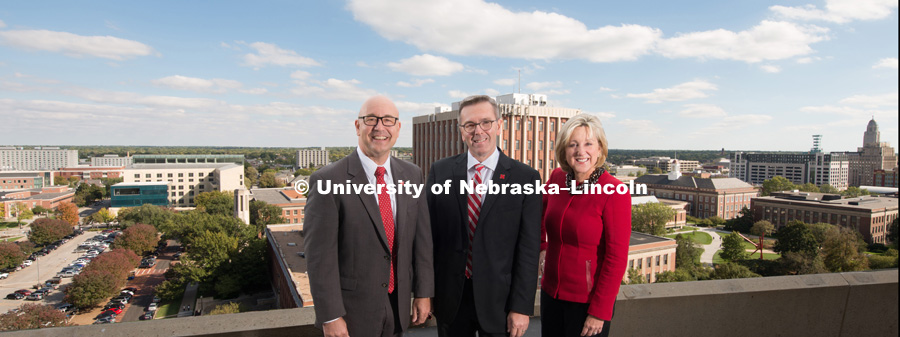 Chancellor Ronnie Green with Vice Chancellors Donde Plowman and Michael Boehm standing on top of a building with the University of Nebraska – Lincoln City Campus in the background. October 10, 2017. Photo by Greg Nathan, University Communication.