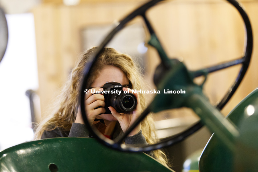 Emily Frenzen, a sophomore from Fullerton, photographs a John Deere tractor in the museum. Students in Jamie Loizzo's ALEC 240 - Digital Photography and Visual Communication for Agriculture and the Environment practice their photography during a field