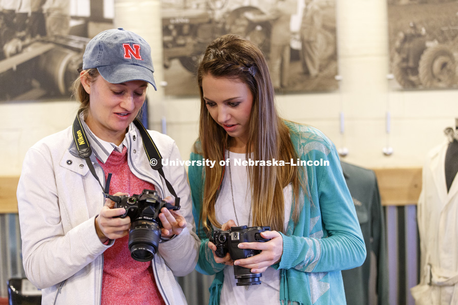 Natalie Jones and Erika Harms review their photos. Students in Jamie Loizzo's ALEC 240 - Digital Photography and Visual Communication for Agriculture and the Environment practice their photography during a field trip to the Larsen Tractor Test Museum.