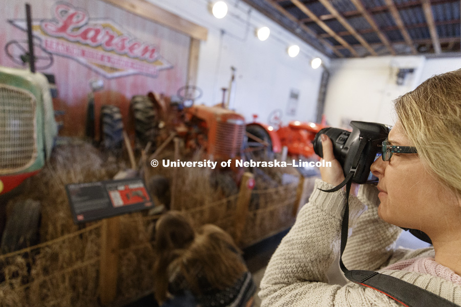 Megan Engel photographs the museum's centerpiece display. Students in Jamie Loizzo's ALEC 240 - Digital Photography and Visual Communication for Agriculture and the Environment practice their photography during a field trip to the Larsen Tractor Test
