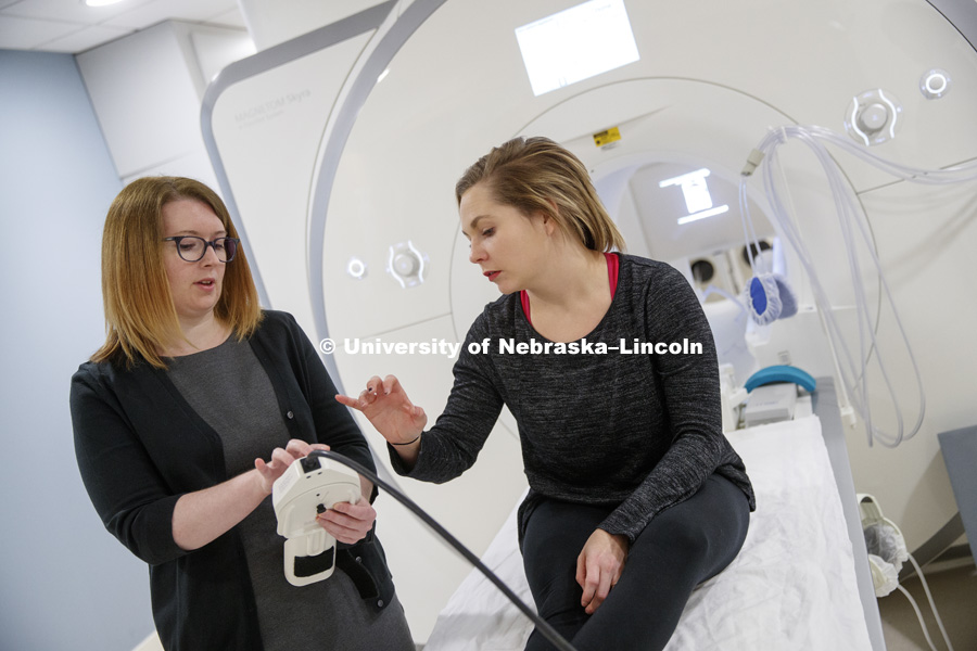 Ingrid Haas, Assistant Professor of Political Science, explains the finger pad to Samantha Lauf so she can answer questions during her MRI. Haas is using CB3's MRI technology to study political perceptions. November 9, 2017. Photo by Craig Chandler /