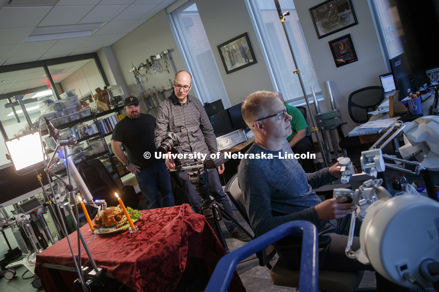 Dave Fitzgibbon of University Communication, and Shane Farritor and his assistant set up the "turkey" and the robot for the photo shoot. Turkey (actually a chicken) is being carved by a robotic surgery device at Virtual Incision, a start up by Nebraska