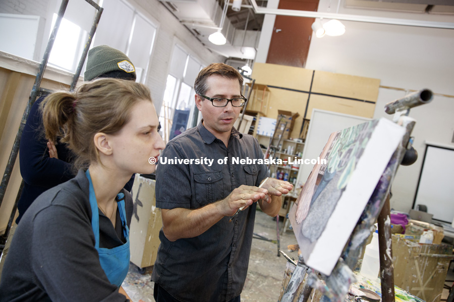 Aaron Holz discusses technique with Sophie Johnson, a junior from Lincoln, during beginning painting class in Richards Hall. The students learn brush strokes and technique by copying a master work of art. PANT 251 - Beginning Painting I. November 27, 2017