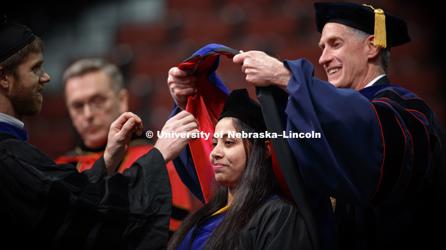 Sandrayee Brahma is hooded by Professor Devin Rose and Tim Carr, Interim Dean of Graduate Education, as she received her doctorate in Food Science and Technology. Graduate Commencement and Hooding ceremony. December 15, 2017. Photo by Craig Chandler /