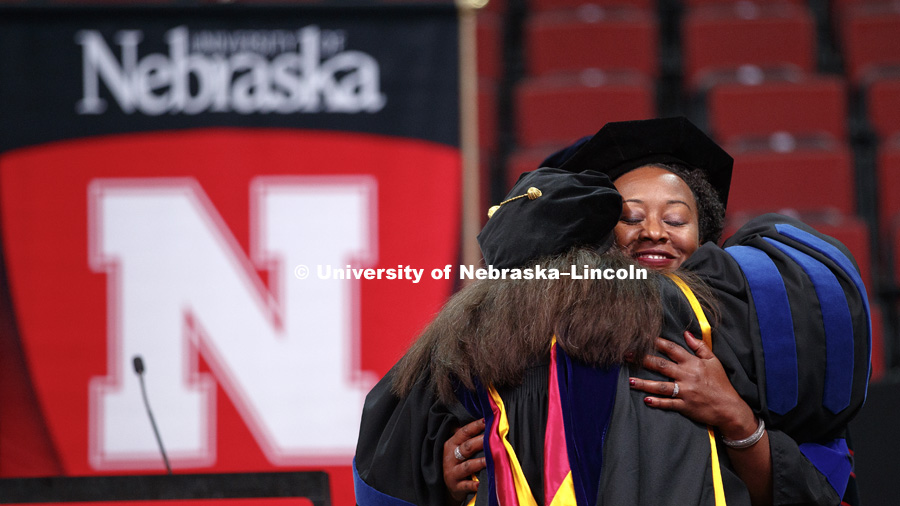 Zantel Nichols is hugged after she received her Doctor of Philosophy in Communications Studies. Graduate Commencement and Hooding ceremony. December 15, 2017. Photo by Craig Chandler / University Communication.