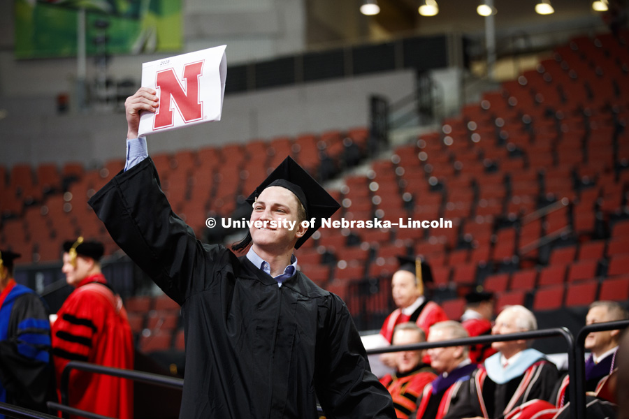 Daniel Carroll shows off his engineering diploma. Undergraduate Commencement at Pinnacle Bank Arena. December 16, 2017. Photo by Craig Chandler / University Communication.