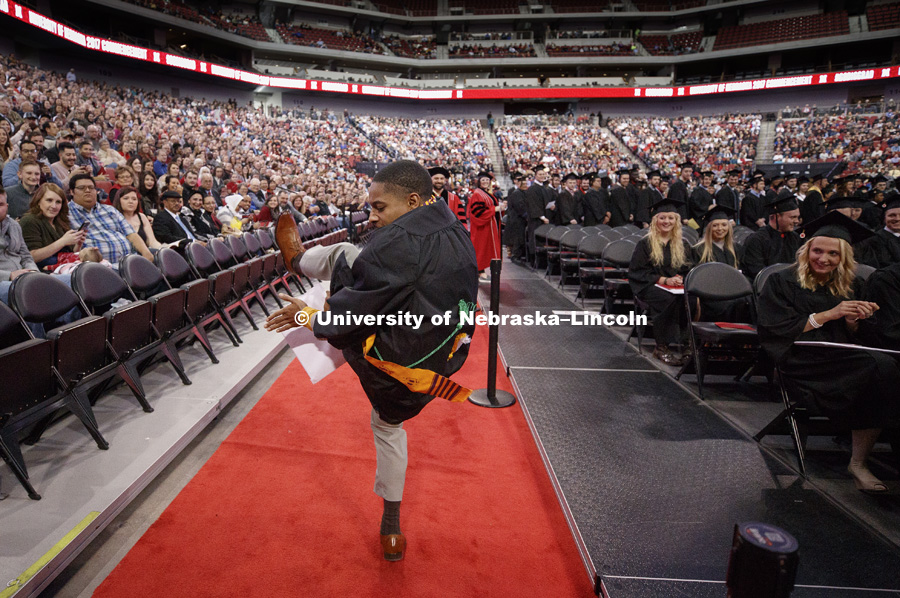 Kristoffer Bridges dances in the aisles after receiving his Engineering degree. Undergraduate Commencement at Pinnacle Bank Arena. December 16, 2017. Photo by Craig Chandler / University Communication.
