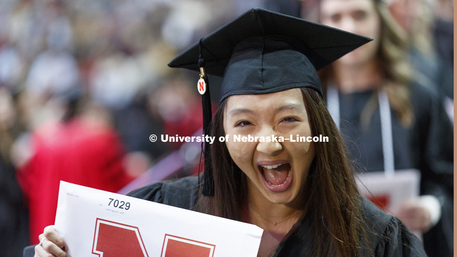 Julia Nguyen cheers after receiving her journalism degree. Undergraduate Commencement at Pinnacle Bank Arena. December 16, 2017. Photo by Craig Chandler / University Communication.