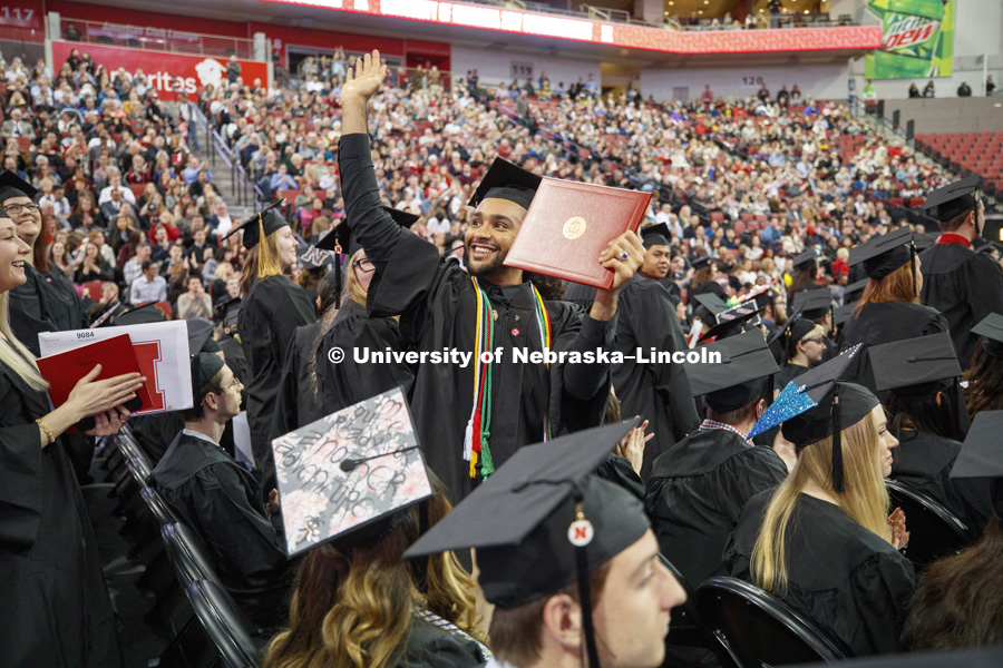 Nadir Al Kharusi shows off his diploma to family and friends Saturday.  Al Kharusi, from Oman, stood after Chancellor Green asked first Nebraska residents, then non-Nebraska residents and finally international graduates to stand and be recognized.