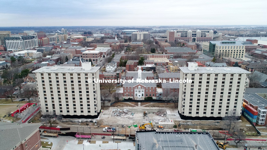 Cather Residence Hall (right) and Pound Residence Hall (left) are to be imploded Friday morning at 9 a.m. The area between the two is the demolished dining center. The surrounding buildings are being protected by walls of fabric to catch dust and any