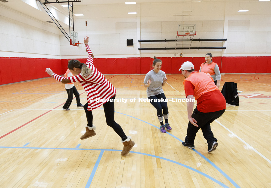 Emily Hetmanek stops before being tagged by Chris Berggren during a game of line tag. Masters students in TEAC 893 Seminar Workshop in Health & Physical Education apply learning principals to physical education games in Mabel Lee hall gymnasium.  January