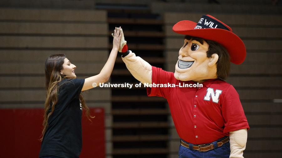 Ayat Aribi, ASUN External Vice President, high fives Herbie Husker after she spoke at the Hate Will Never Win rally at the Coliseum. February 14, 2018. Photo by Craig Chandler / University Communication