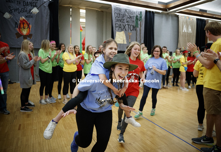 Miracle Child Willa gets a lift from Allie Kingsley, a Delta Gamma, as Willia is carried through a cheering tunnel of students to start the marathon. 1274 Nebraska students signed up to be part of the Huskerthon Dance Marathon for Children's Hospital in