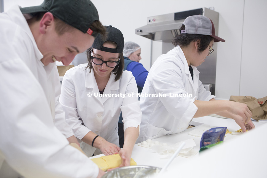 Alec Alvarez (left) and Madeline Kramp roll dough for fried ravioli while Shane Nguyen (right) and Jessica Goens help cook during the 2018 Battle of the Food Scientists at the Food Innovation Center on Nebraska Innovation Campus. February 28, 2018. Photo