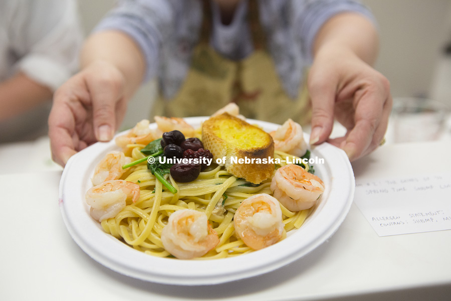 Dr. Heather Hallen-Adams sets out one of Team Two's finished plates of linguine pasta during the 2018 Battle of the Food Scientists at the Food Innovation Center on Nebraska Innovation Campus. February 28, 2018. Photo by James Wooldridge, for University