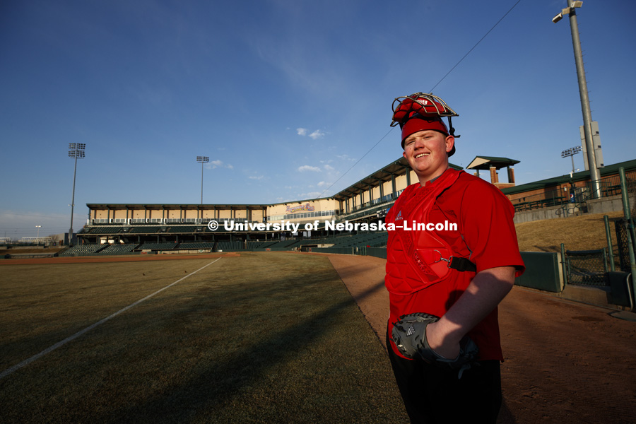 Kendrick Umphreys, a freshman in nutrition and health sciences and a first generation student, is continuing his love of baseball at Nebraska by working as the bullpen warm-up catcher for the Husker baseball team. March 9, 2018. Photo by Craig Chandler /