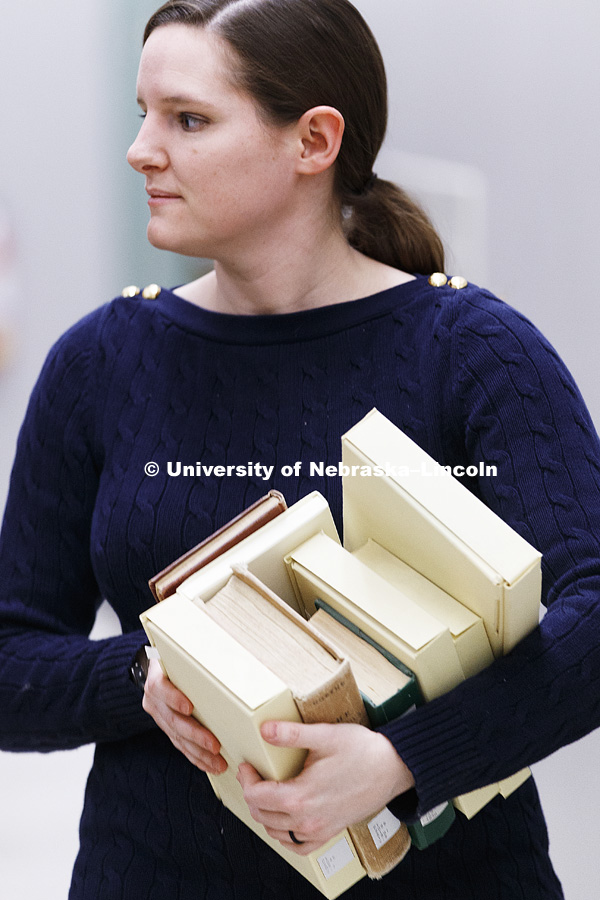 Erin Chambers carries a load of books to be documented. The basement of Love Library north filled with hunters looking to document interesting bits of history in handwritten margin notes, photographs and other objects. Crowd-sourced digital humanities