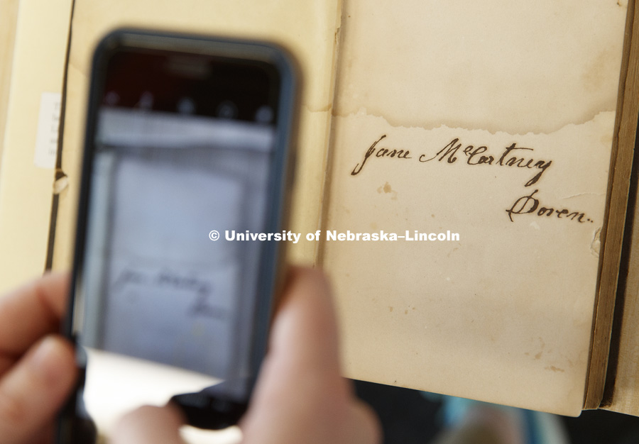 The basement of Love Library north filled with hunters looking to document interesting bits of history in handwritten margin notes, photographs and other objects. Crowd-sourced digital humanities project, Book Traces. The event was led by Peter Capuano,
