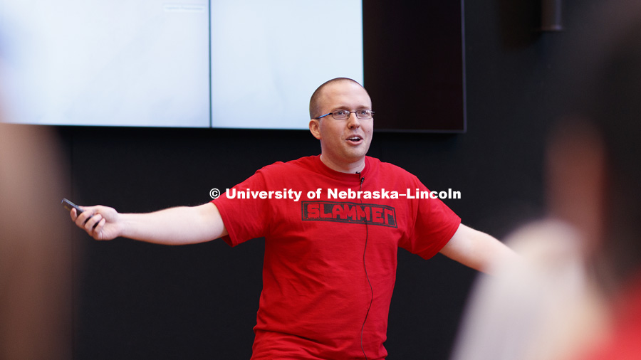 Andrew Connor, graduate student in mathematics, gives his slam speech. Science Slam is a campus-wide contest where graduate and undergraduate researchers from ALL SCIENTIFIC DISCIPLINES are challenged to communicate their work in short, dynamic, and