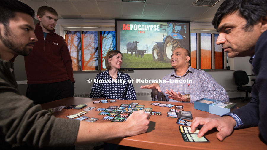 Jeyam Subbiah, Professor for the College of Engineering, Biological Systems Engineering, is pictured with Jenny Keshwani (checked blouse), Ashu Guru (dark sweater), and grad students. A group of collaborators who put their diverse skills together to develop AgPocalypse 2050, a game for middle school and high school students to promote learning about ag decisions and processes. Photo for the 2018 publication of the Strategic Discussions for Nebraska magazine. April 4, 2018. Photo by Greg Nathan, University Communication.