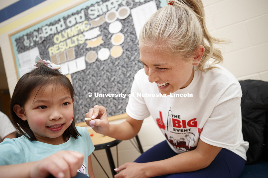 Madison Blum, Beatrice, Nebraska, does face painting at the Campbell Elementary School Carnival during the Big Event. April 7, 2018. Photo by Craig Chandler / University Communication.