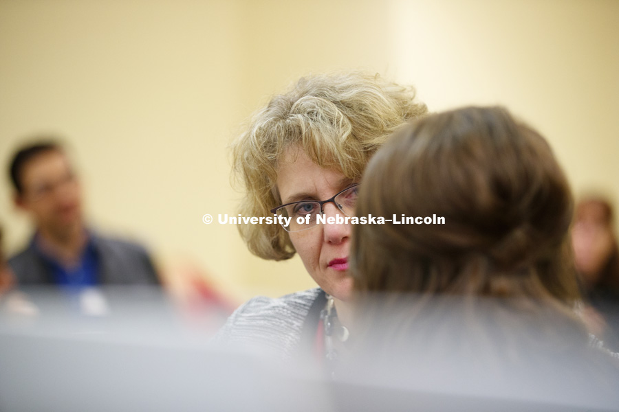Senator Sue Crawford listens to a student researcher during the session. State Senators Research Fair at the Capitol. April 10, 2018. Photo by Craig Chandler / University Communication.