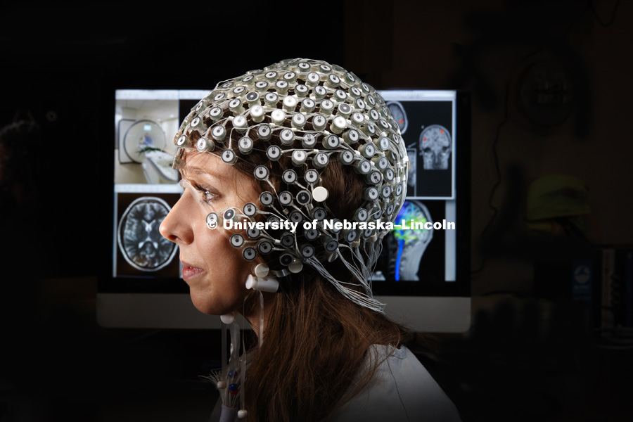 Jessie Tibbs, graduate student in clinical neuropsychology, demonstrates the MRI compatible High Density EEG Net. Photographed for the N150 anniversary book. April 13, 2019. Photo by Craig Chandler / University Communication.