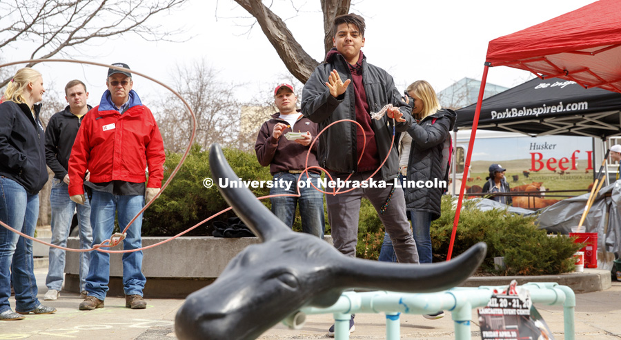 Eric Adame, an architecture student from Lincoln, tries his hand at roping a plastic steer. Husker Food Connection helps urban students learn about agriculture and better understand how their food is produced. Husker Food Connection in front of the