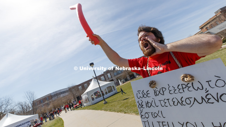 Dylan Severino, senior in classical languages, wears a gyro sign as he calls out to fellow students to attend the Homerthon. The university’s first-ever Homerathon — a marathon reading of “Iliad” — will begin 7 a.m. April 19 on the Meier Commons green