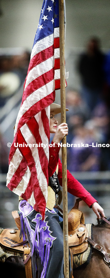 Miss Rodeo University of Nebraska-Lincoln Shelby Riggs brings in the American flag to begin the rodeo. 60th anniversary of the University of Nebraska-Lincoln Rodeo Club. April 20, 2018. Photo by Craig Chandler / University Communication.