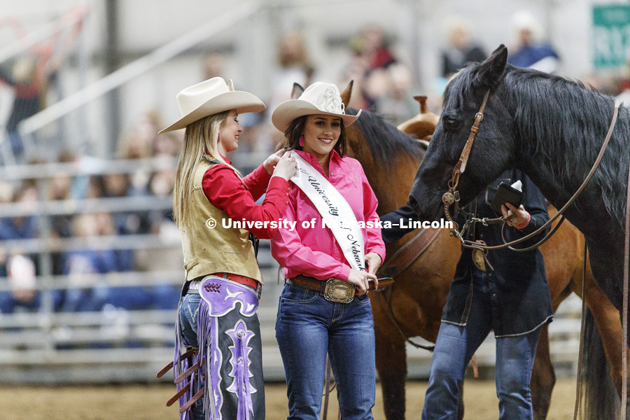 The new Miss Rodeo University of Nebraska-Lincoln, Jennifer Stroh has her sash pinned on by the outgoing Miss Rodeo Shelby Riggs. 60th Anniversary of the University of Nebraska-Lincoln Rodeo Club. April 20, 2018. Photo by Craig Chandler / University