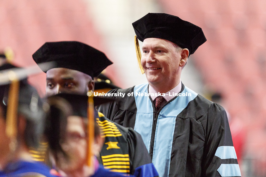 Brad Stauffer smiles as he walks into Graduate Commencement in Pinnacle Bank Arena. May 4, 2018. Photo by Craig Chandler / University Communication.