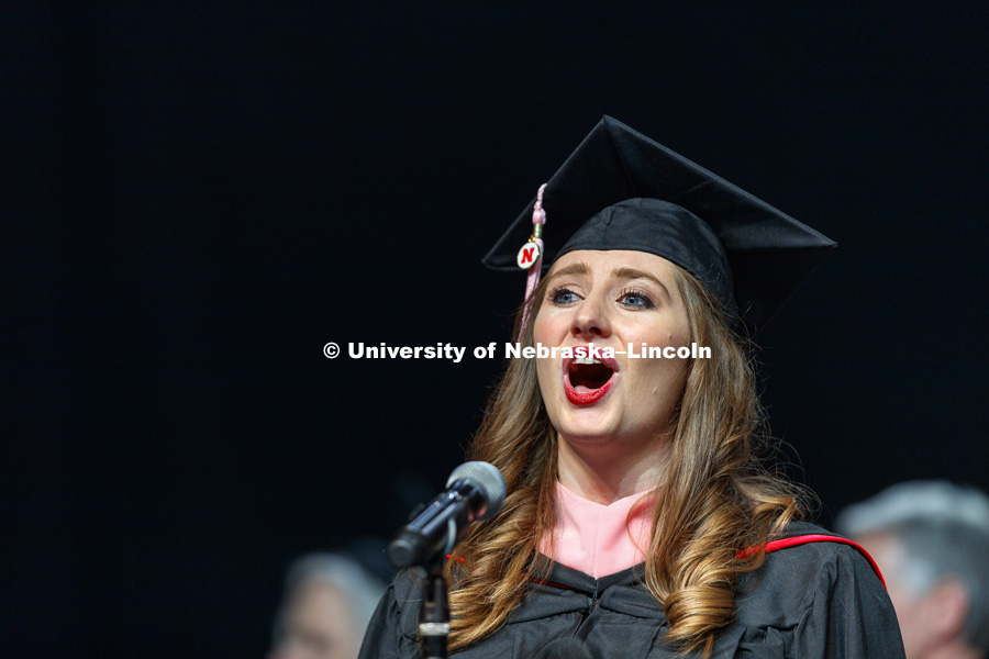 Arica Colemen, master of music degree candidate, sings the national anthem to begin Graduate Commencement at Pinnacle Bank Arena. May 4, 2018. Photo by Craig Chandler / University Communication.