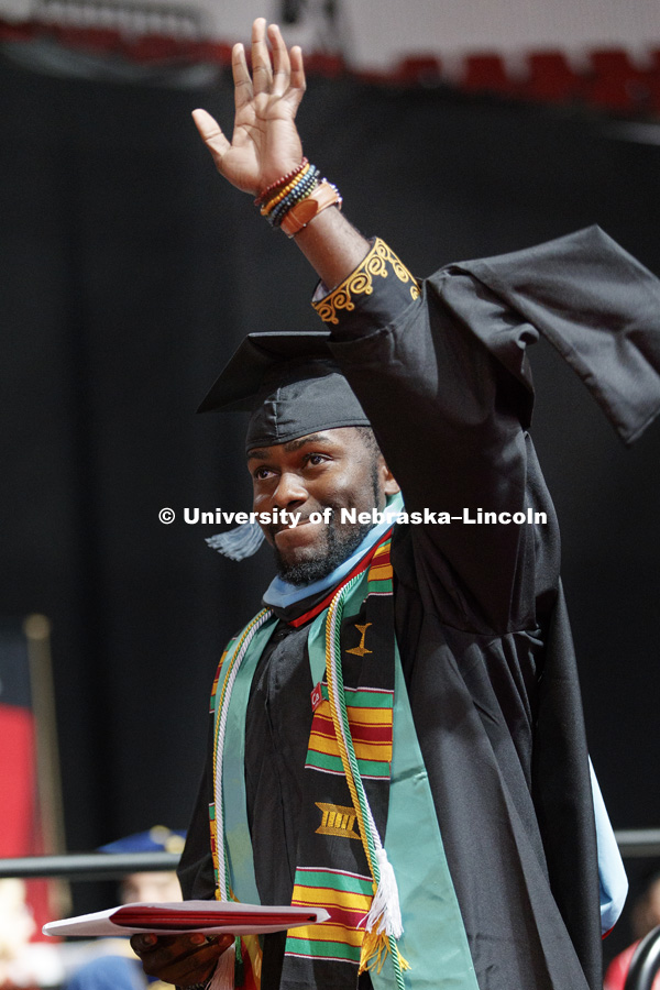 Yves Bemba Kitsoro waves after receiving his Graduate Commencement at Pinnacle Bank Arena. May 4, 2018. Photo by Craig Chandler / University Communication.