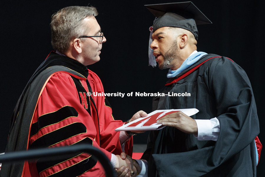 Phillip Foster is congratulated by Chancellor Ronnie Green as Foster receives his master of educational administration. Graduate Commencement at Pinnacle Bank Arena. May 4, 2018. Photo by Craig Chandler / University Communication.
