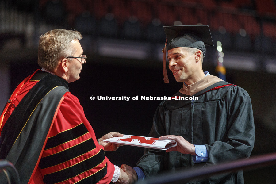 Tyrell Ross receives his MBA from Chancellor Ronnie Green at the Graduate Commencement at Pinnacle Bank Arena. May 4, 2018. Photo by Craig Chandler / University Communication.