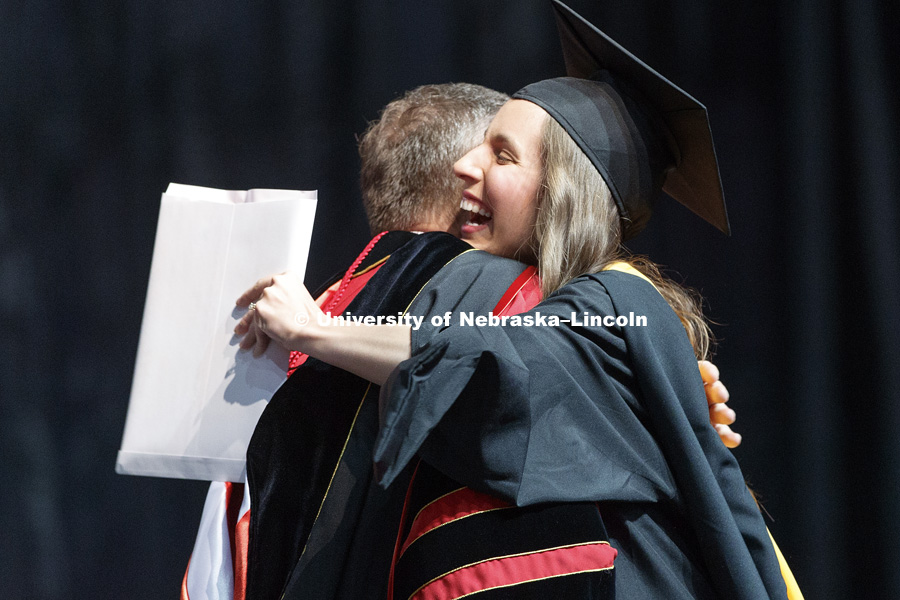 Hannah Sunderman hugs Chancellor Ronnie Green after she received her master of science degree. Graduate Commencement at Pinnacle Bank Arena. May 4, 2018. Photo by Craig Chandler / University Communication.