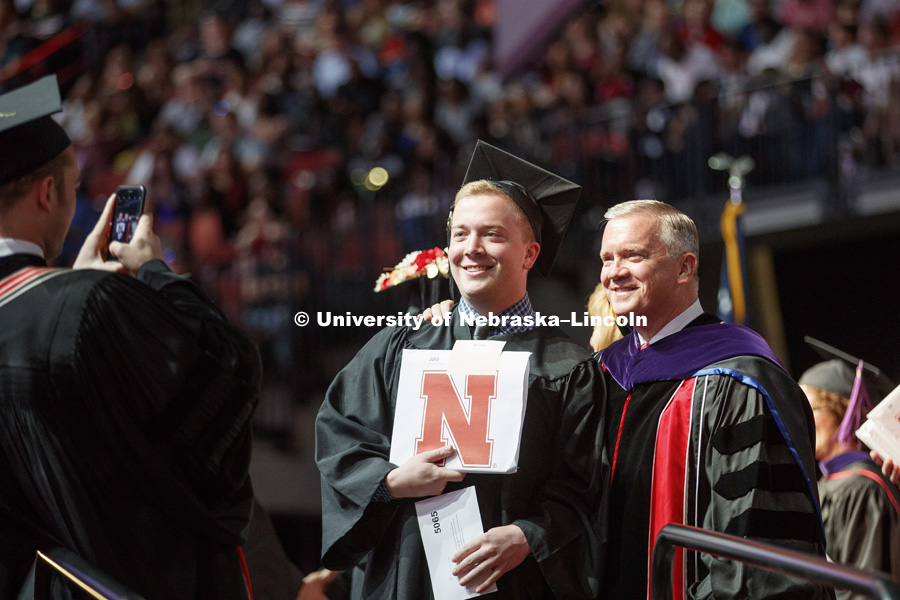 Daniel Clare poses for a photo after receiving his business diploma from his dad, Nebraska Regent Tim Clare. Undergraduate Commencement at Pinnacle Bank Arena. May 5, 2018. Photo by Craig Chandler / University Communication.