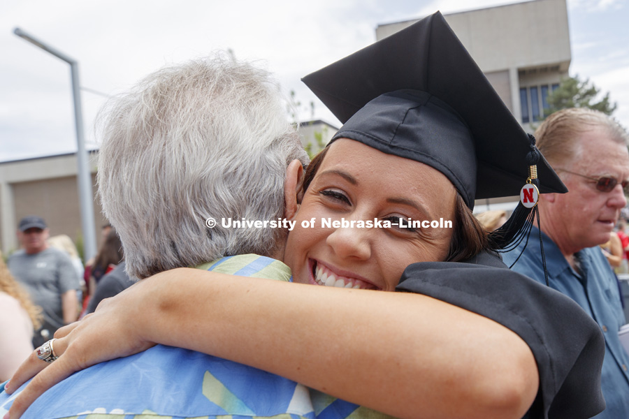 Carlye Reed receives a hug outside Pinnacle Bank Arena following commencement. Undergraduate Commencement at Pinnacle Bank Arena. May 5, 2018. Photo by Craig Chandler / University Communication.