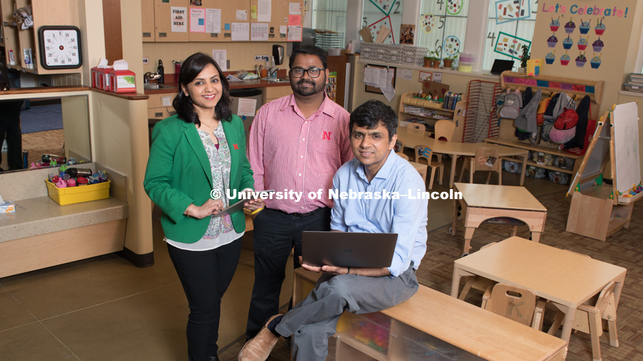Dipti Dev (green jacket) with collaborators Santosh Pitla (red striped shirt) and Ashu Guru (blue shirt). Dipti is an Assitant Professor for The College of Education and Human Sciences, Child, Youth and Family Studies, Santosh is an Assistant Professsor for the College of Engineering, Biological Systems Engineering, and Ashu is an Assistant Professor and Courtesy Assistant Professor for the College of Engineering, Biological Systems Engineering and 4-H Youth Development. Together they are working to change childhood eating behaviors by combining education and technology to help parents and children. Photo for the 2018 publication of the Strategic Discussions for Nebraska magazine. May 21, 2018. Photo by Greg Nathan, University Communication.