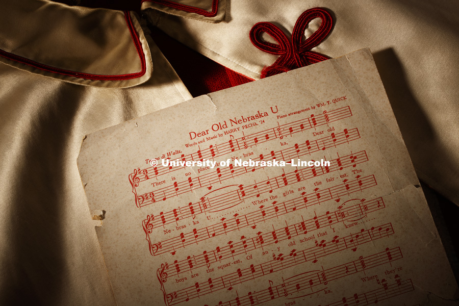 Dear Old Nebraska U sheet music lies on an old drum major cape which now resides in the Alumni Center. Photographed for the N150 anniversary book. May 24, 2018. Photo by Craig Chandler / University Communication.