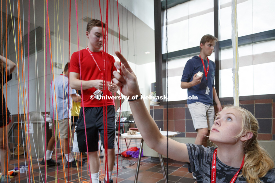 High School summer camp students in Architecture make string designs in the Link of Architecture Hall. June 21, 2018. Photo by Craig Chandler / University Communication.