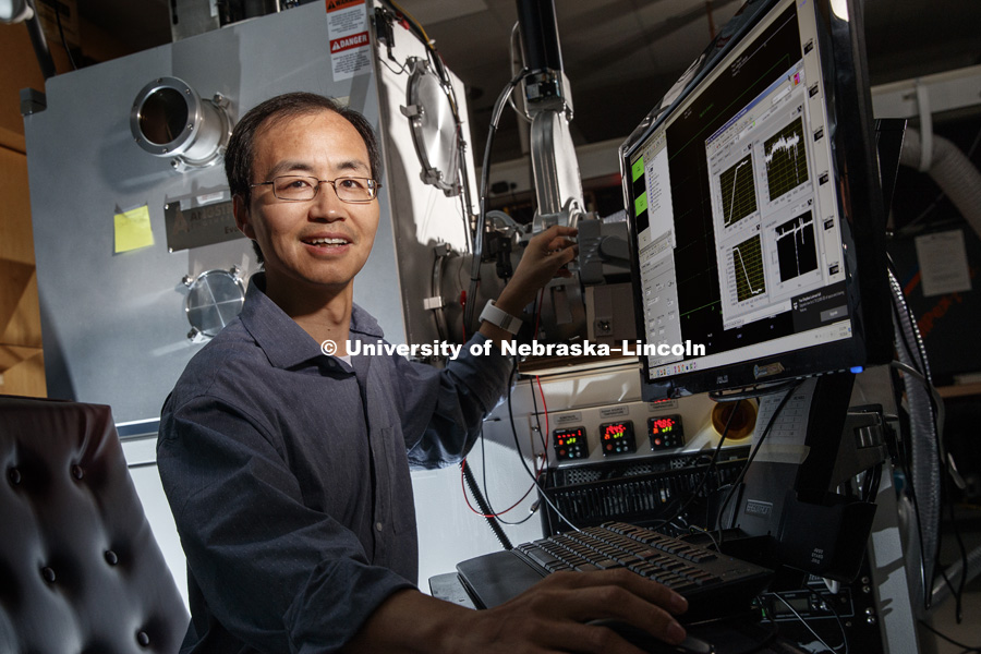 Xiaoshan Xu, assistant professor of physics and astronomy, has received a 2018 Early Career Award from the U.S. Department of Energy.Xiaoshan works on organic electrical circuits. July 5, 2018. Photo by Craig Chandler / University Communication.