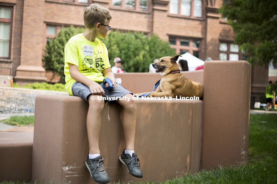 Lane Stevens relaxes with the family dog, Koda, during the Husker Dog fest on August 11, 2018 on the University of Nebraska-Lincoln Campus. Photo by Alyssa Mae for University Communication.