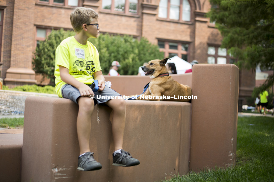 Lane Stevens relaxes with the family dog, Koda, during the Husker Dog fest on August 11, 2018 on the University of Nebraska-Lincoln Campus. Photo by Alyssa Mae for University Communication.