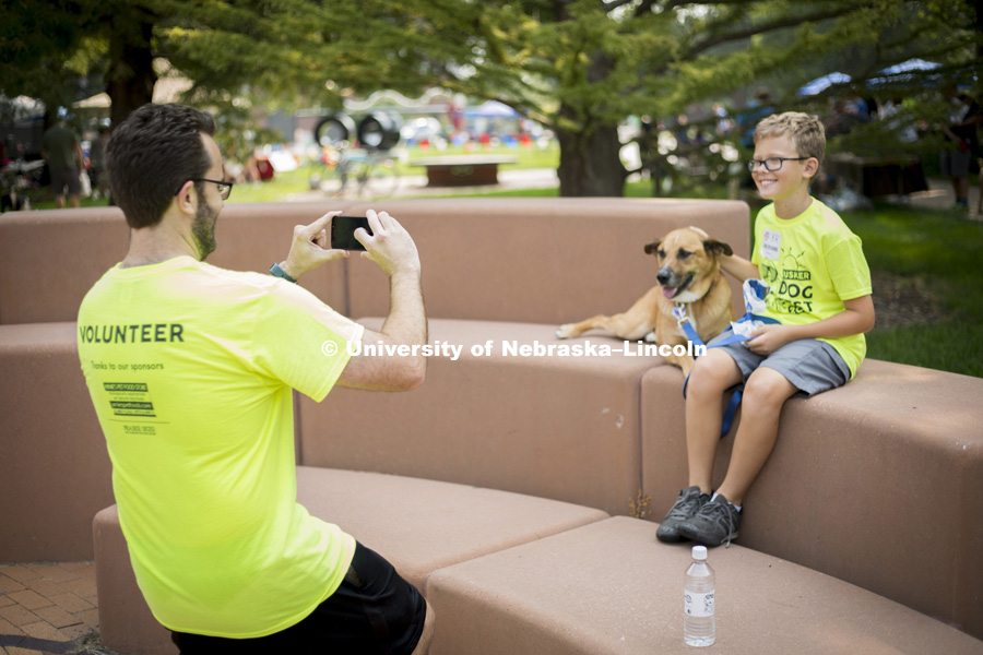 Jeffery Stevens (left), organizer of the Husker Dog Fest, snaps a picture of his son, Lane Stevens, and the family dog, Koda, on August 11, 2018 on the University of Nebraska-Lincoln Campus. Photo by Alyssa Mae for University Communication.