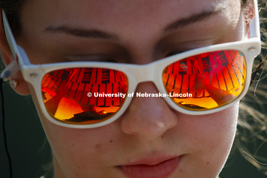 Morgan Grabowski's mallets are reflected in her sunglasses as she practices the vibraphone during Cornhusker Marching Band practice. August 12, 2018. Photo by Craig Chandler / University Communication.