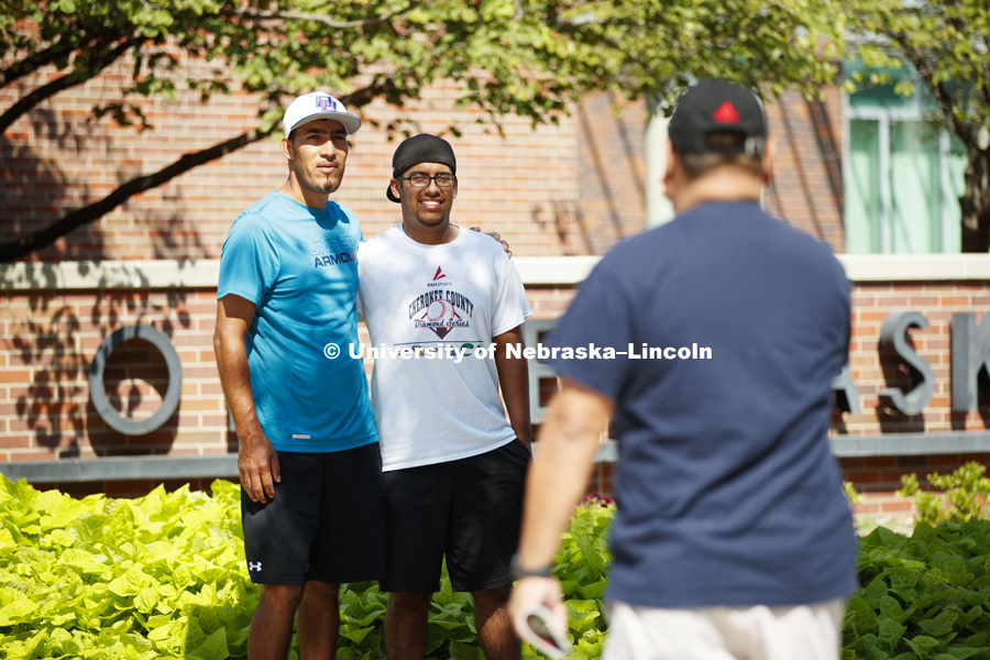 Freshman Alejandro Morales, Jr., right, poses with his dad, Alejandro Morales, Sr., outside the visitors center. Residence Hall move-in. August 16, 2018. Photo by Craig Chandler / University Communication.
